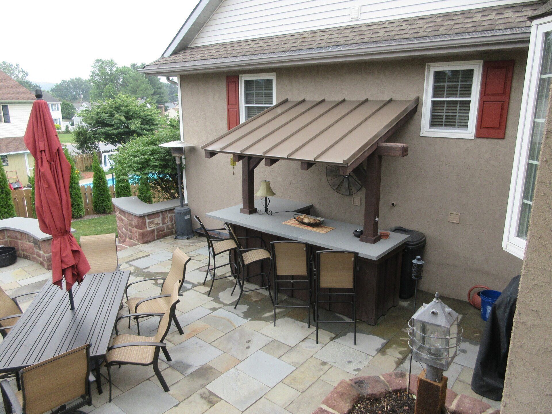 A patio with a table and chairs under a canopy