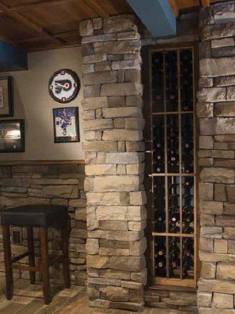A wine cellar with a brick wall and a wine rack filled with wine bottles.
