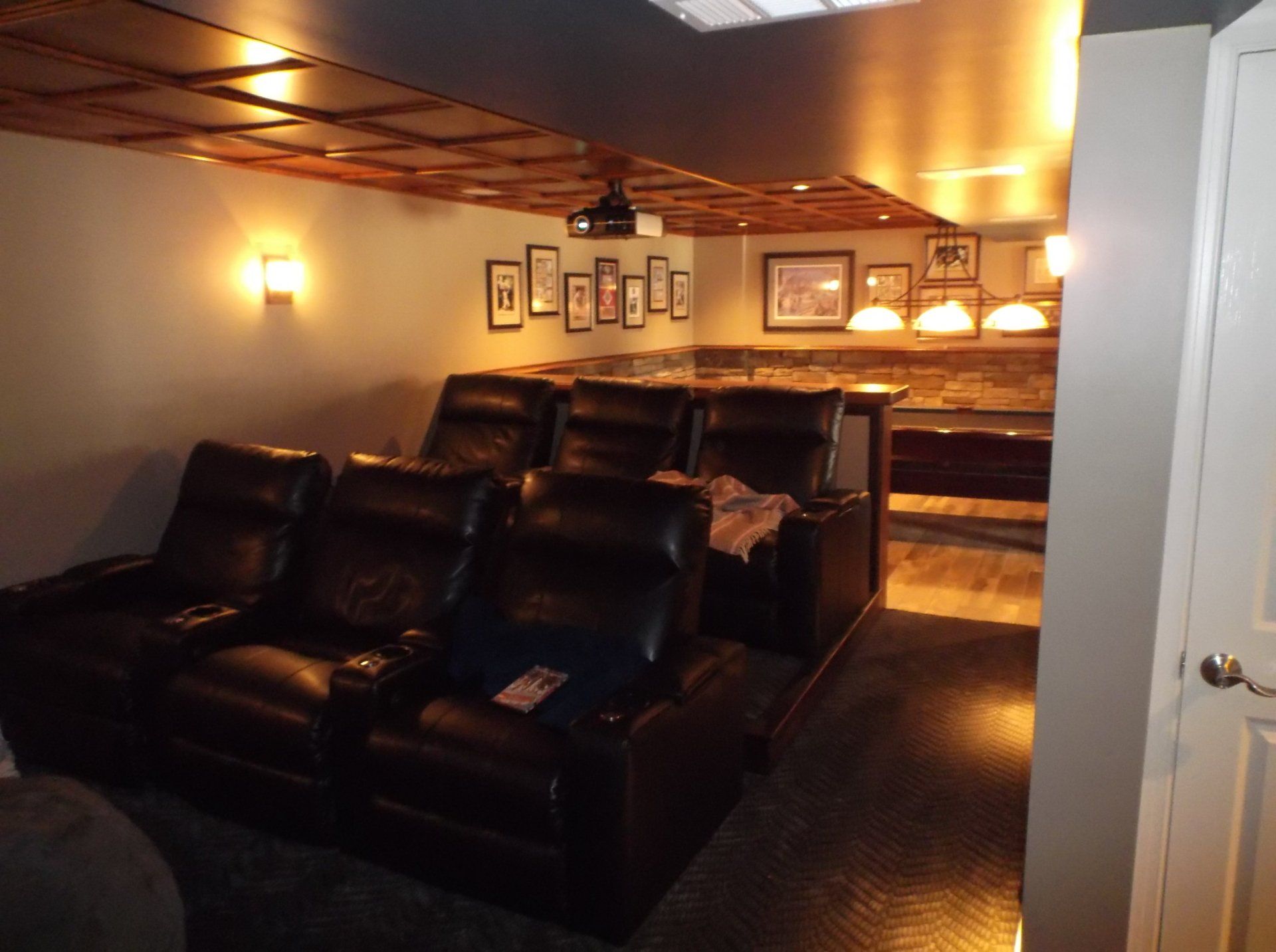 A room with a lot of chairs and pictures on the wall