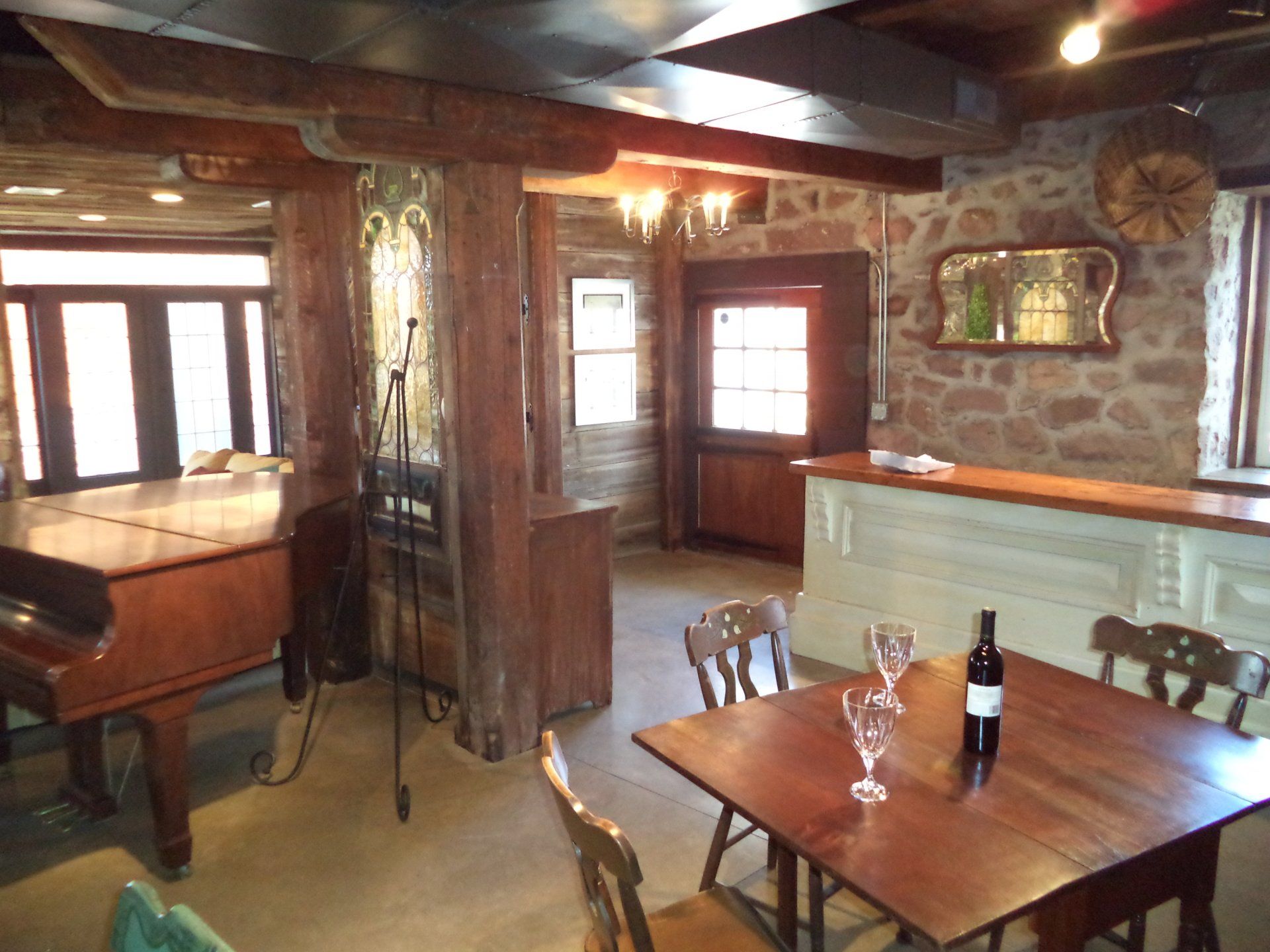 A table with a bottle of wine and two glasses on it