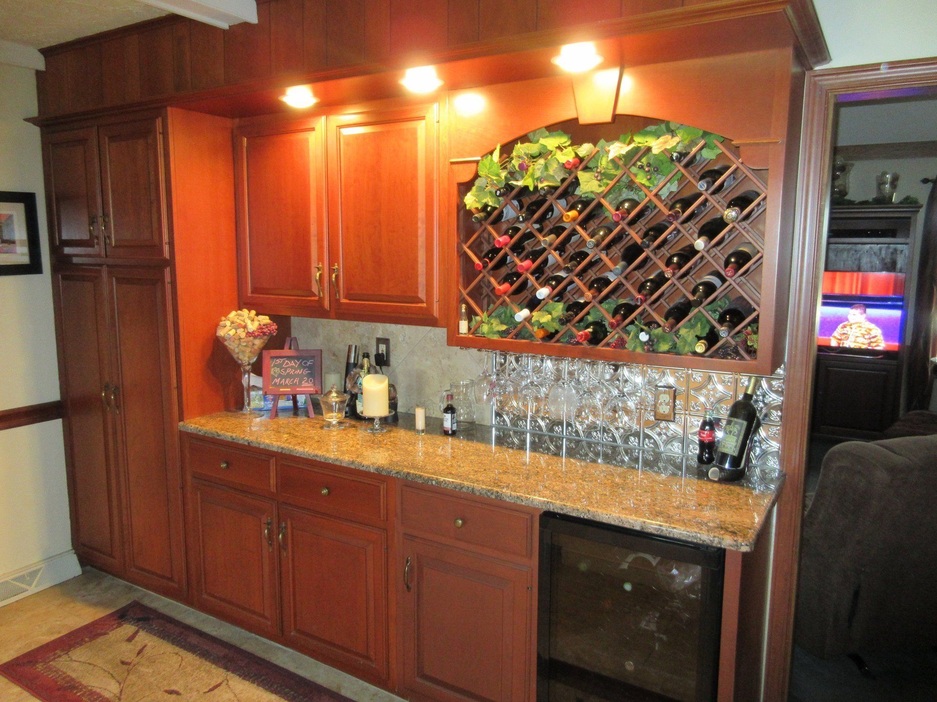 A kitchen with lots of cabinets and a wine rack