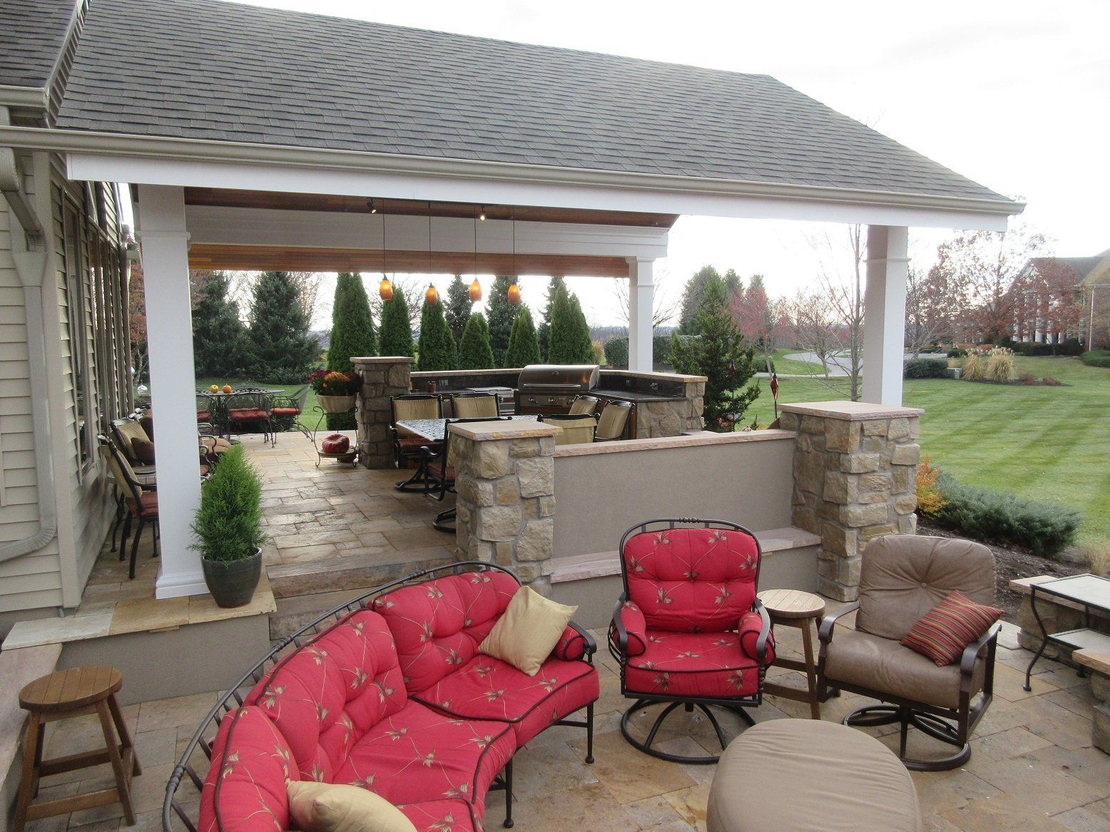 A patio with a couch and chairs under a pavilion