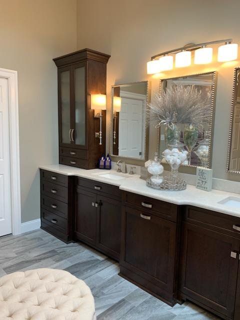 A bathroom with two sinks and a large mirror