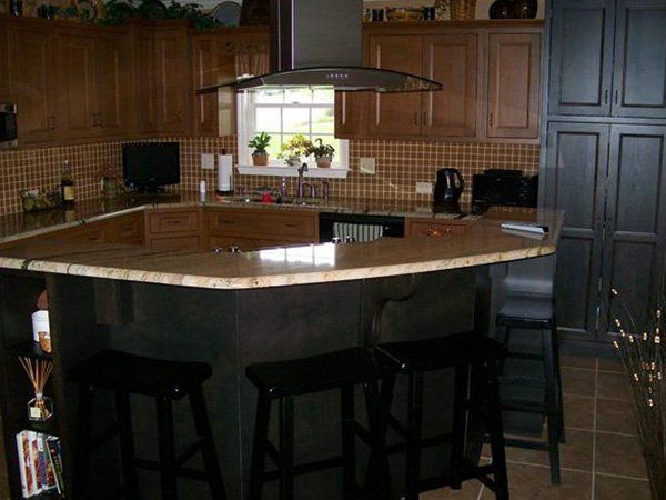 A kitchen with a large island and stools