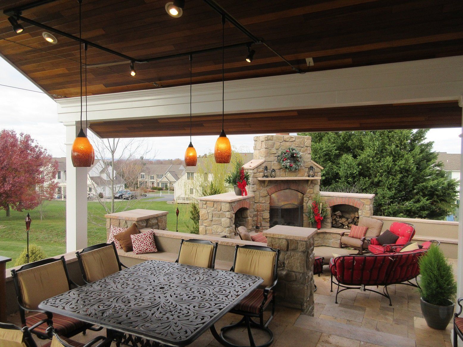 A patio with a table and chairs and a fireplace