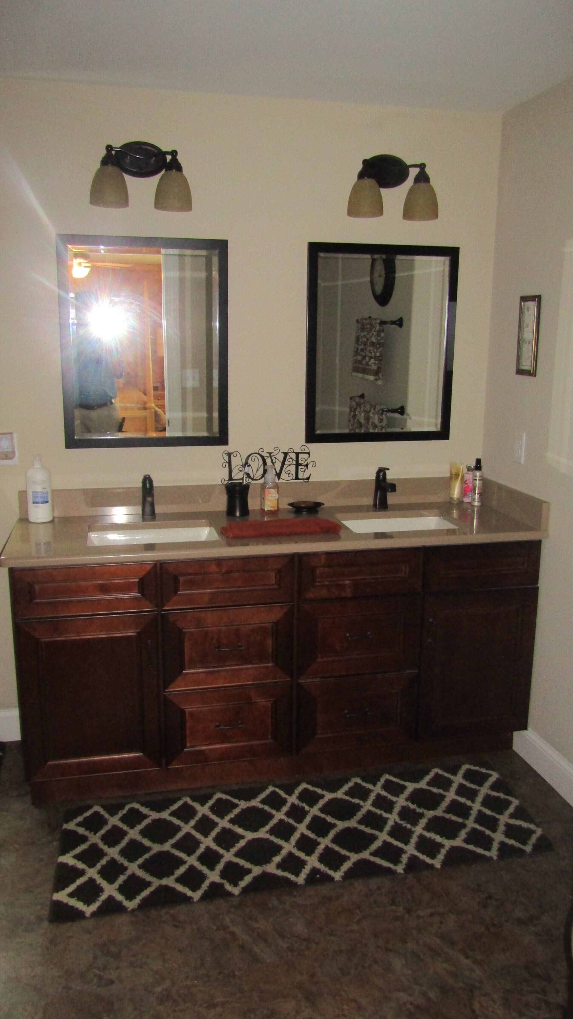 A bathroom with two sinks and two mirrors
