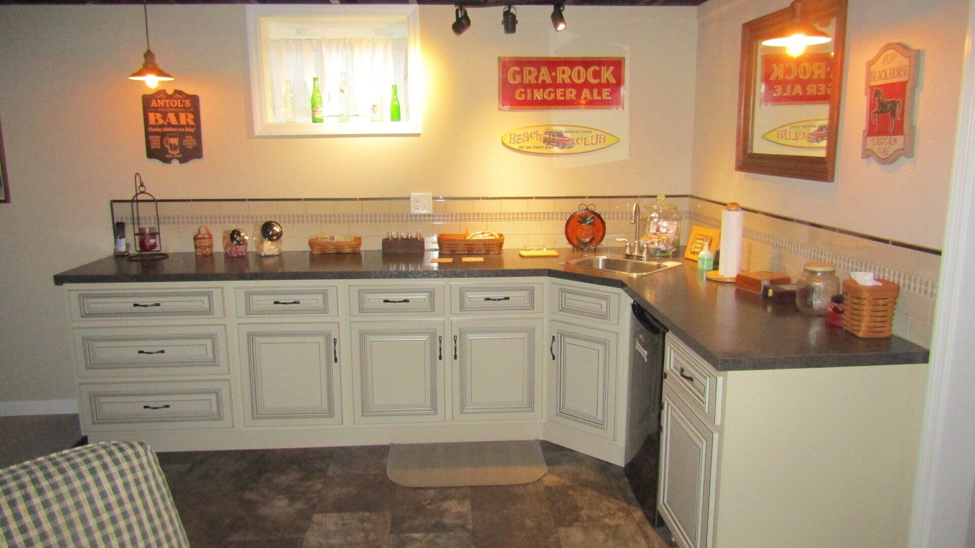 A kitchen with white cabinets and a sign that says crab rock on the wall.