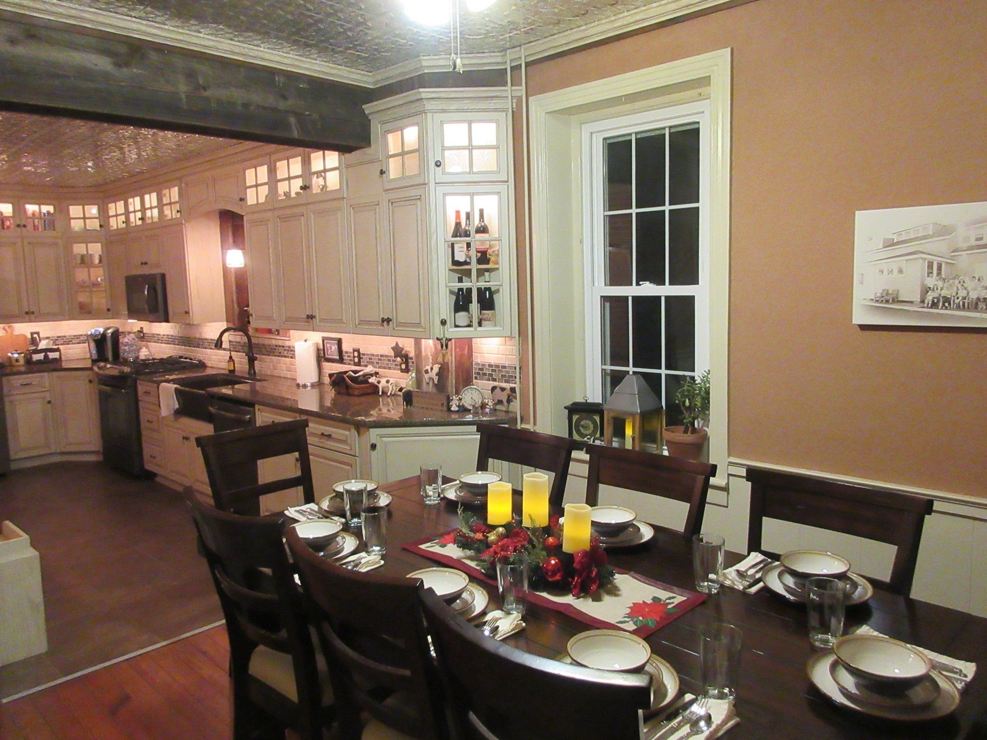 A dining room table with plates and candles on it