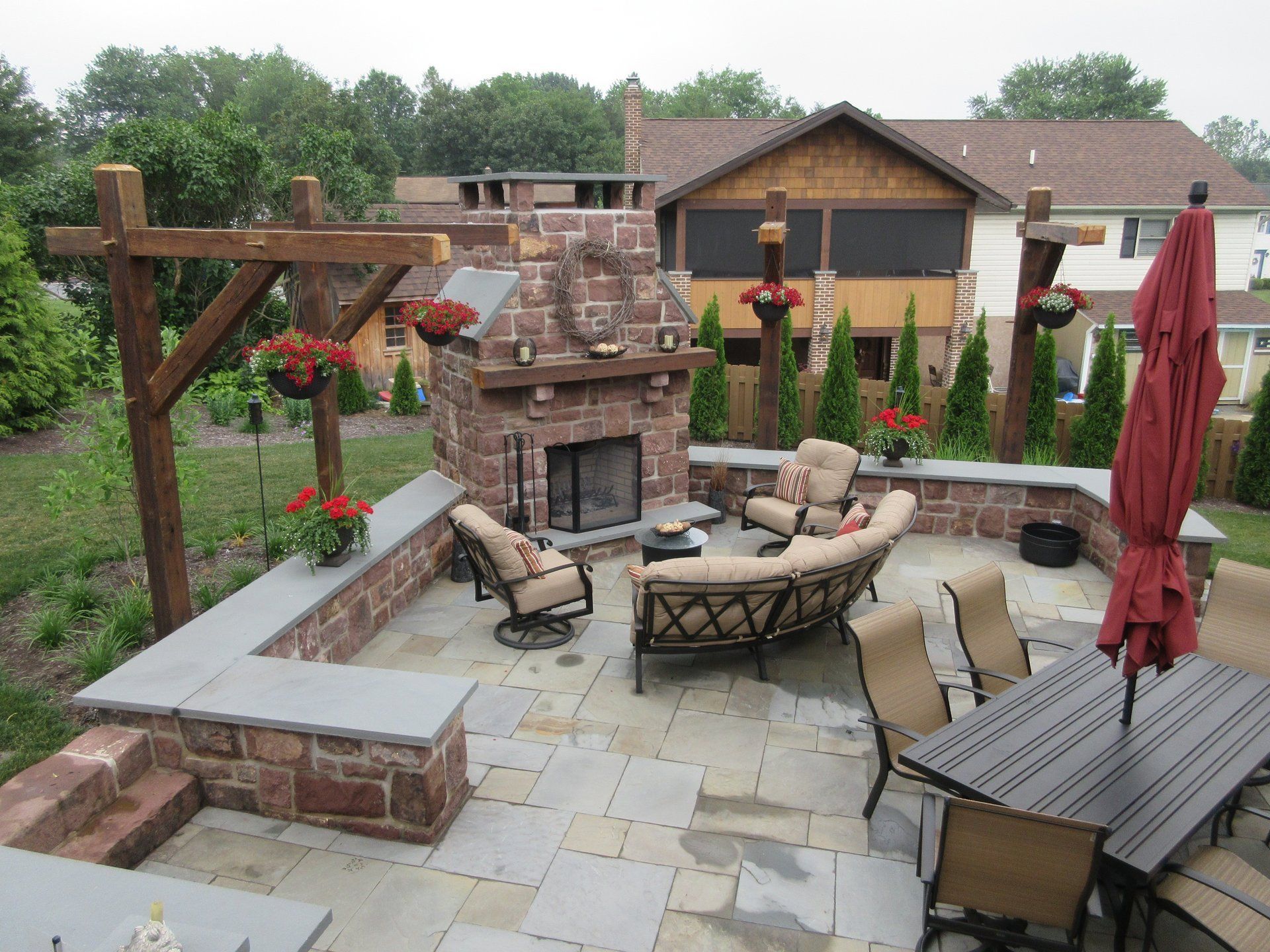 A patio with a fireplace and a table and chairs