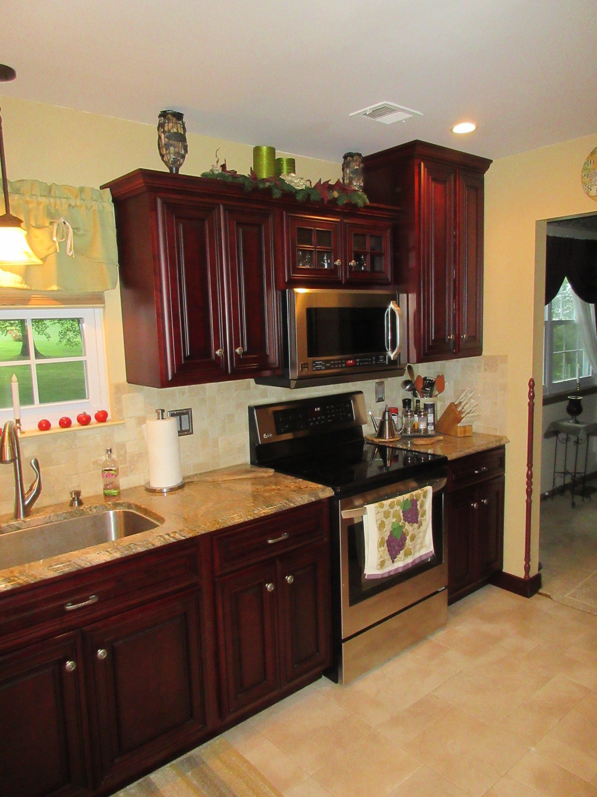 A kitchen with stainless steel appliances and wooden cabinets