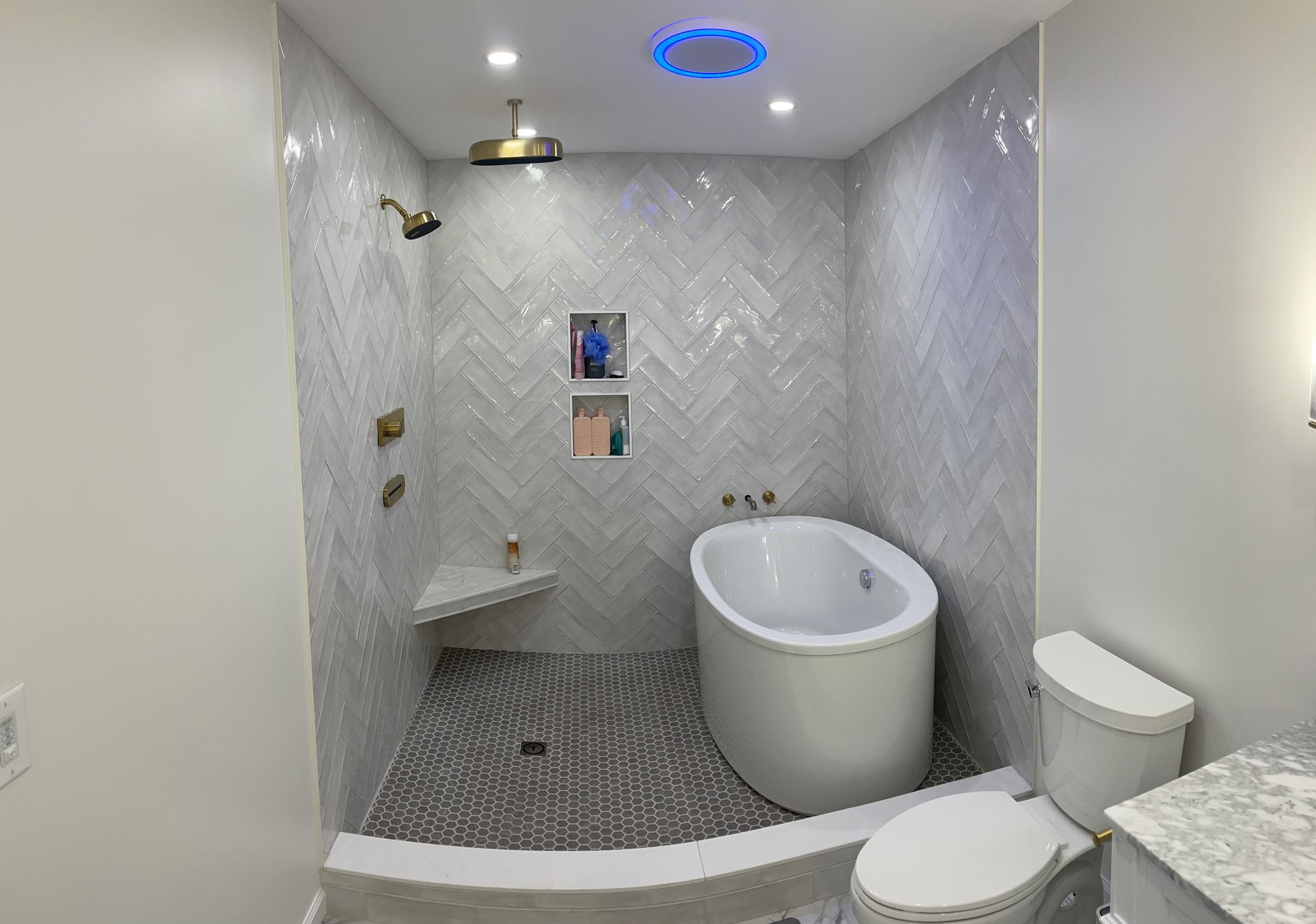 A bathroom with a tub , toilet and shower.