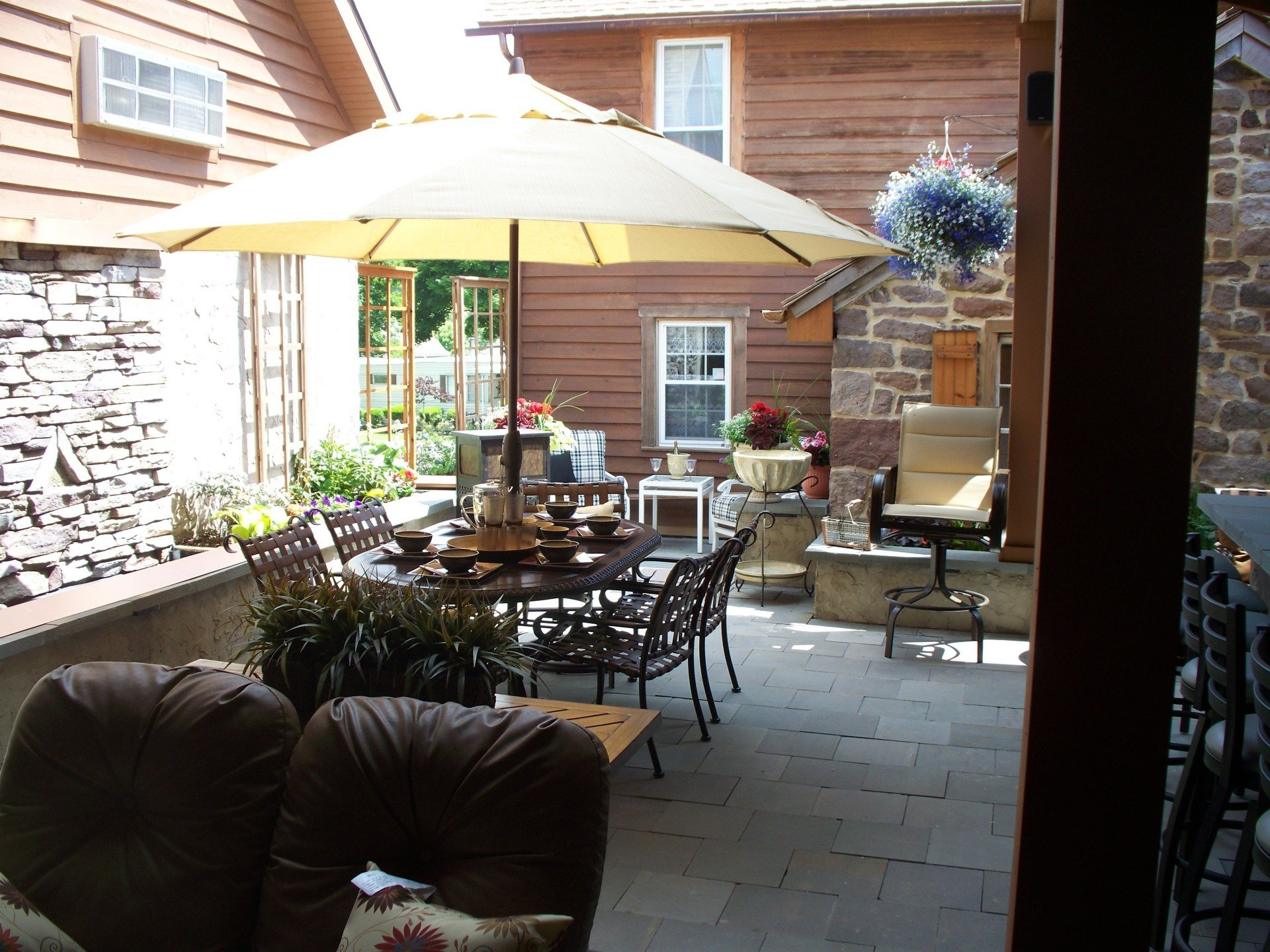 A patio with a table and chairs under an umbrella