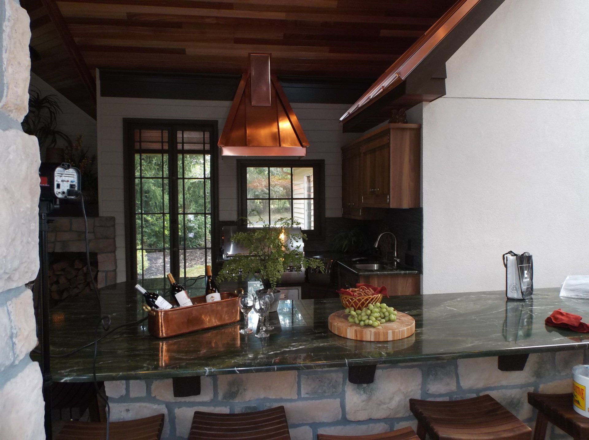 A kitchen with a copper hood above the counter