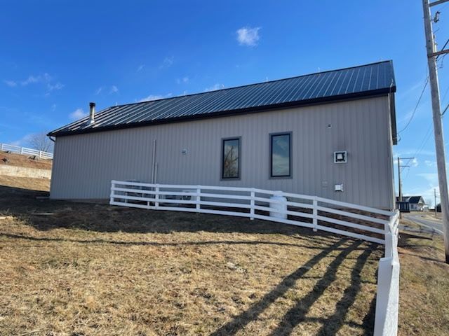 A house with a white fence in front of it.