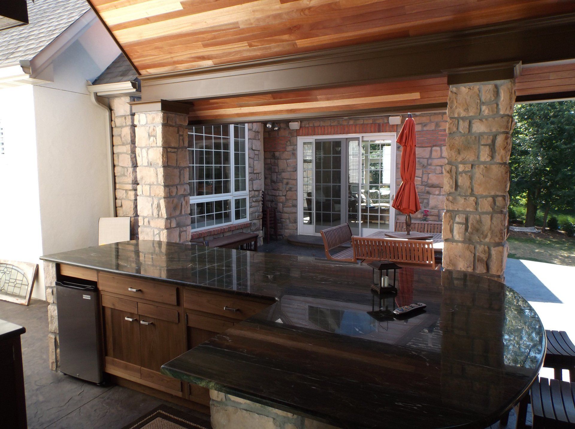 A kitchen with a granite counter top and a sliding glass door
