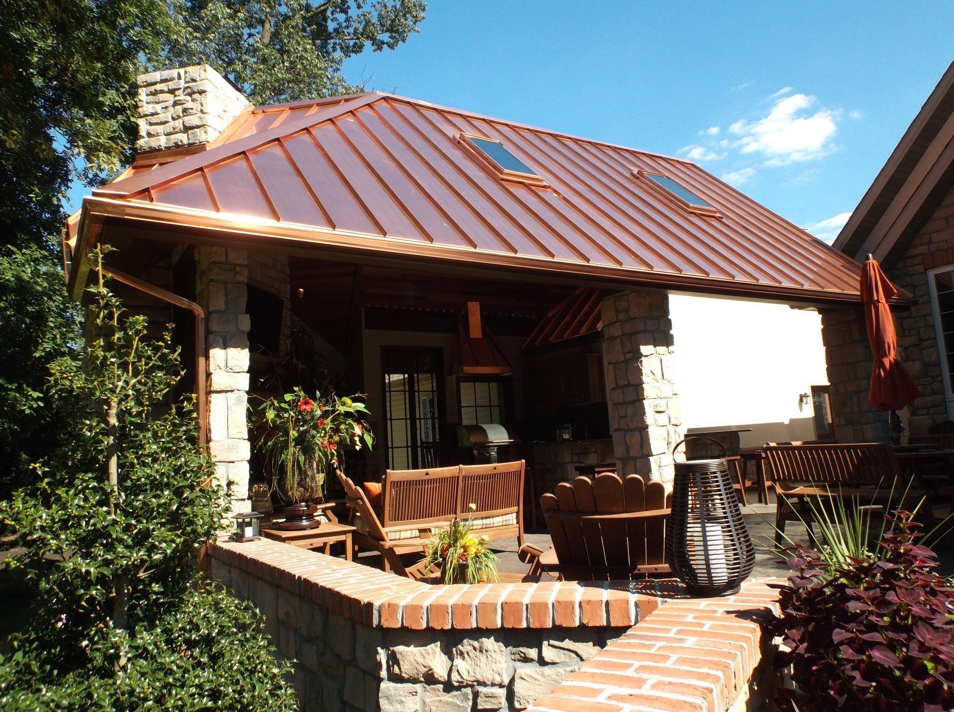 A house with a copper roof and a brick porch