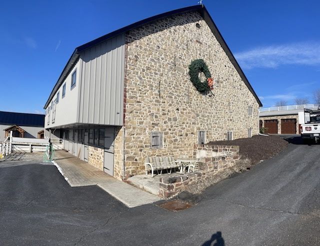 A large stone building with a wreath on the side