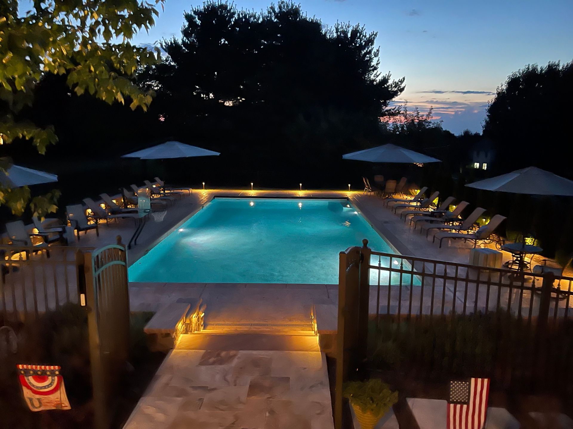 A large swimming pool is lit up at night