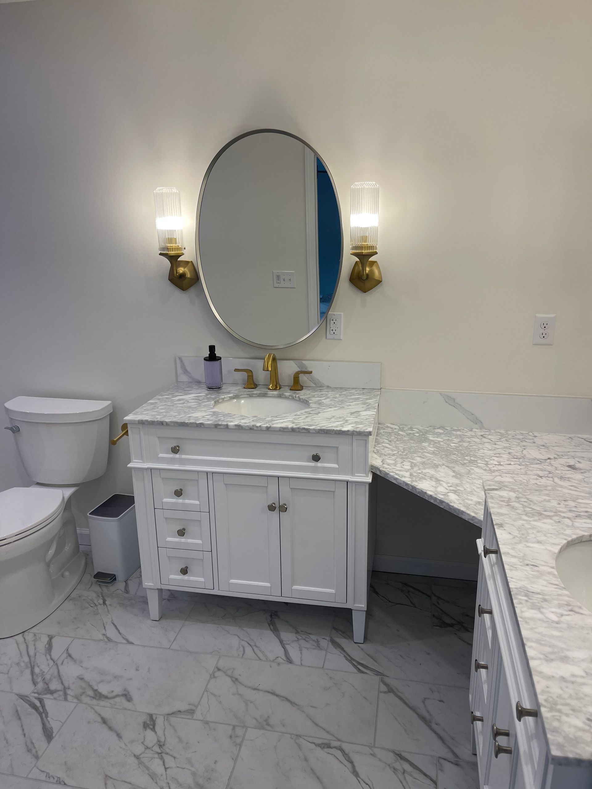 A bathroom with a sink , toilet , and mirror.