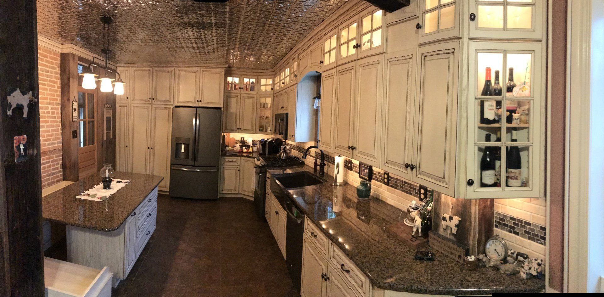 A kitchen with white cabinets and granite counter tops