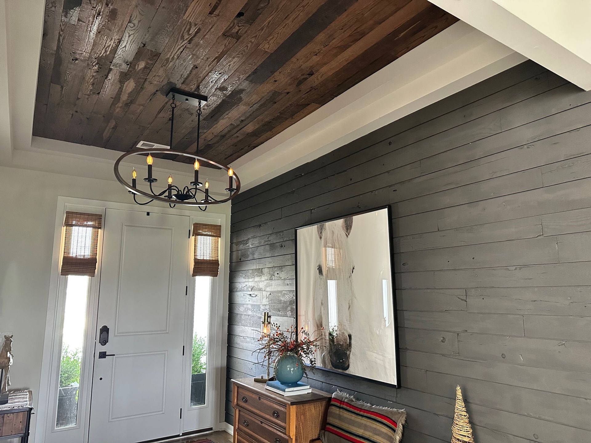 A hallway with a wooden ceiling and a mirror.