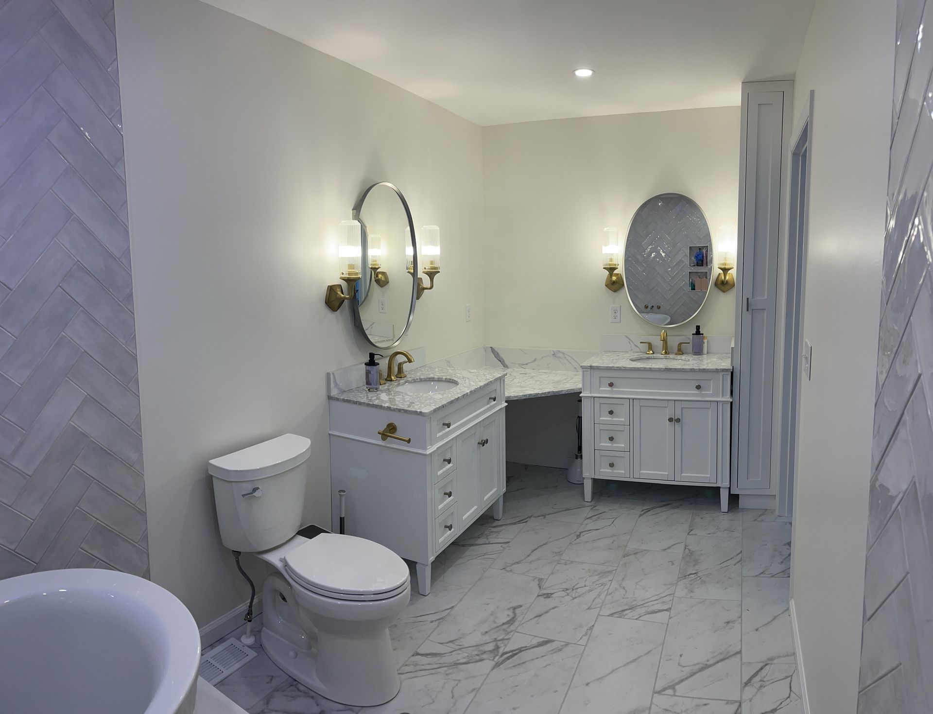 A bathroom with a toilet , sink , mirror and bathtub.