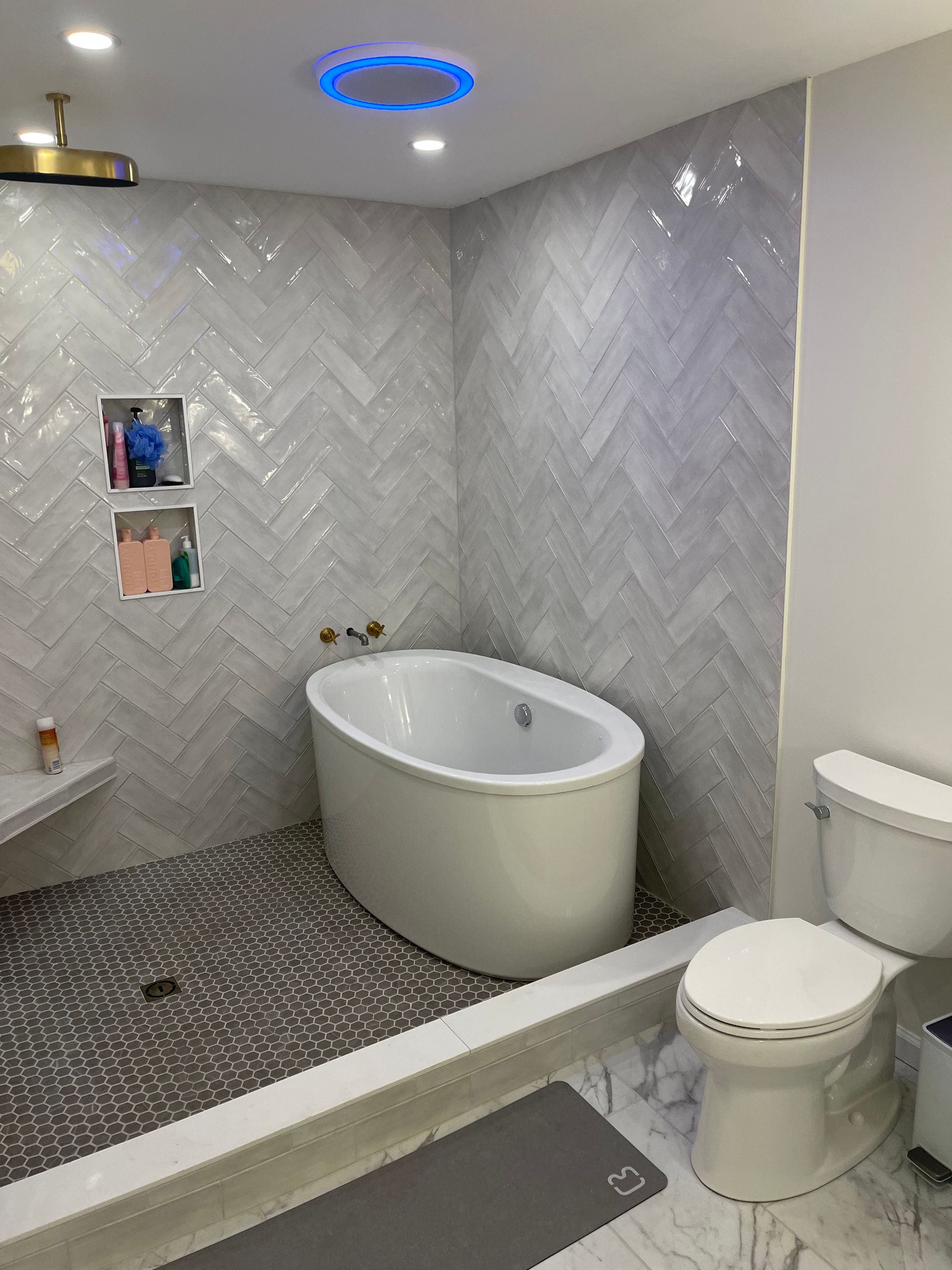 A bathroom with a tub , toilet and shower.