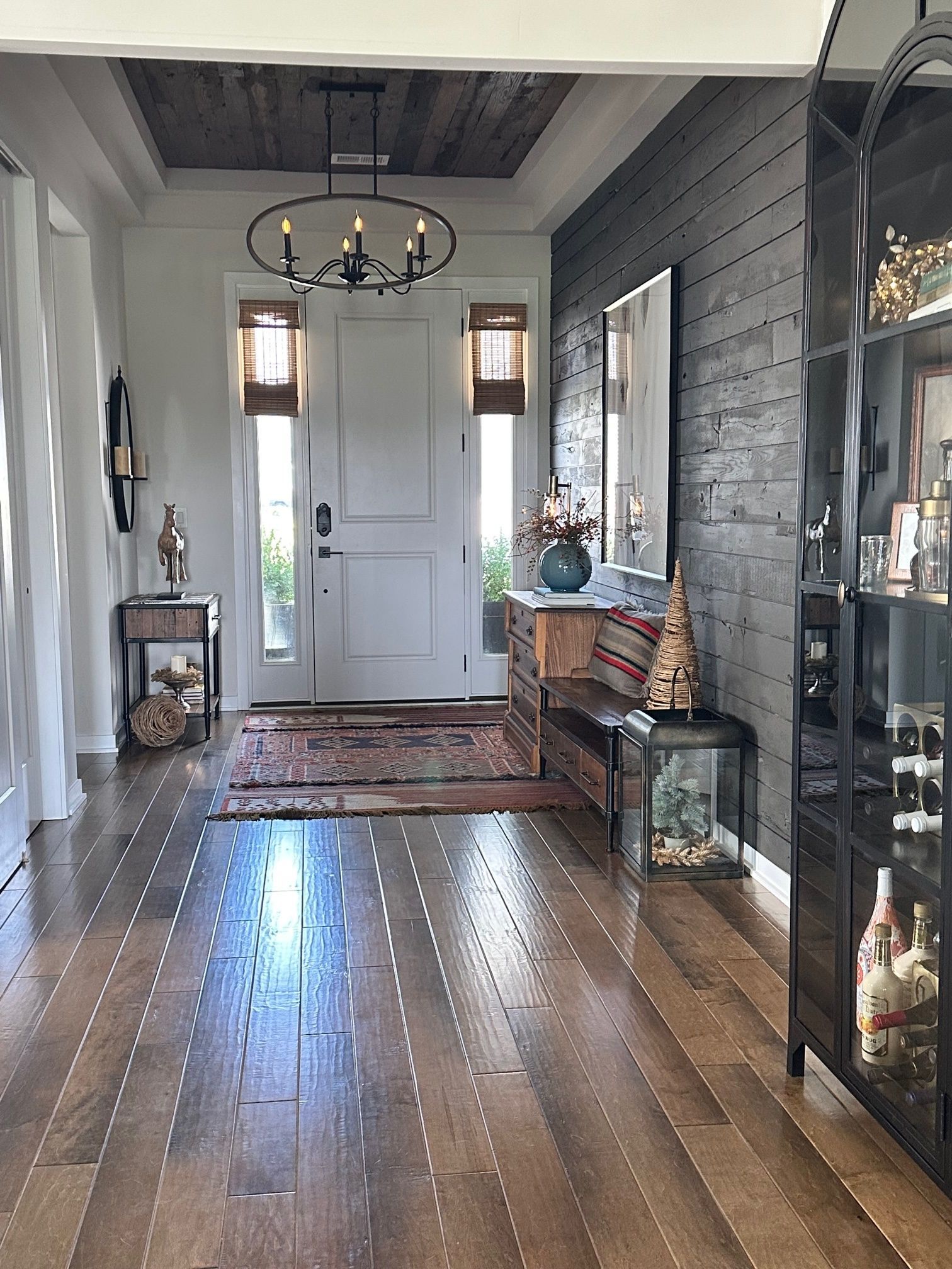 A hallway with hardwood floors and a white door.