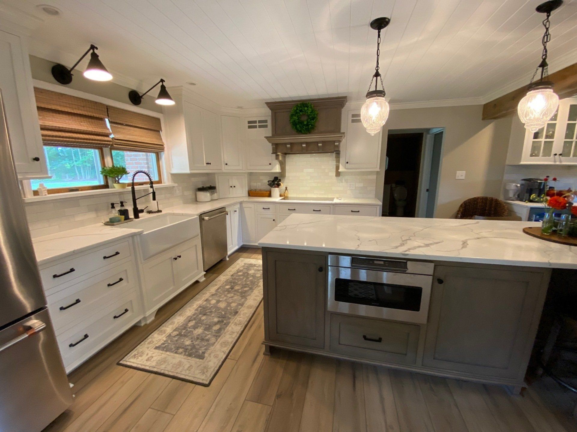 A kitchen with white cabinets and stainless steel appliances