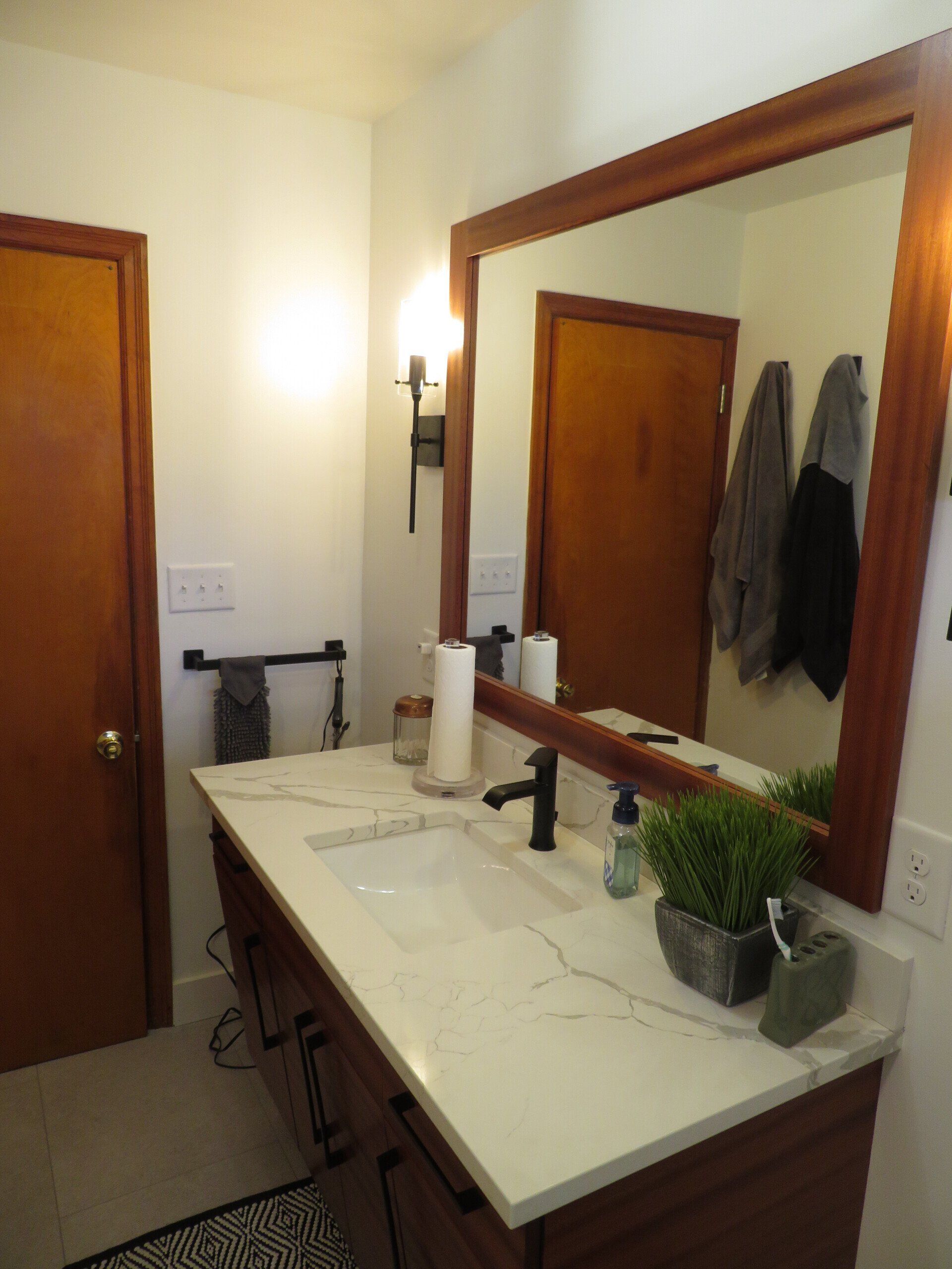 A bathroom with two sinks and a large mirror