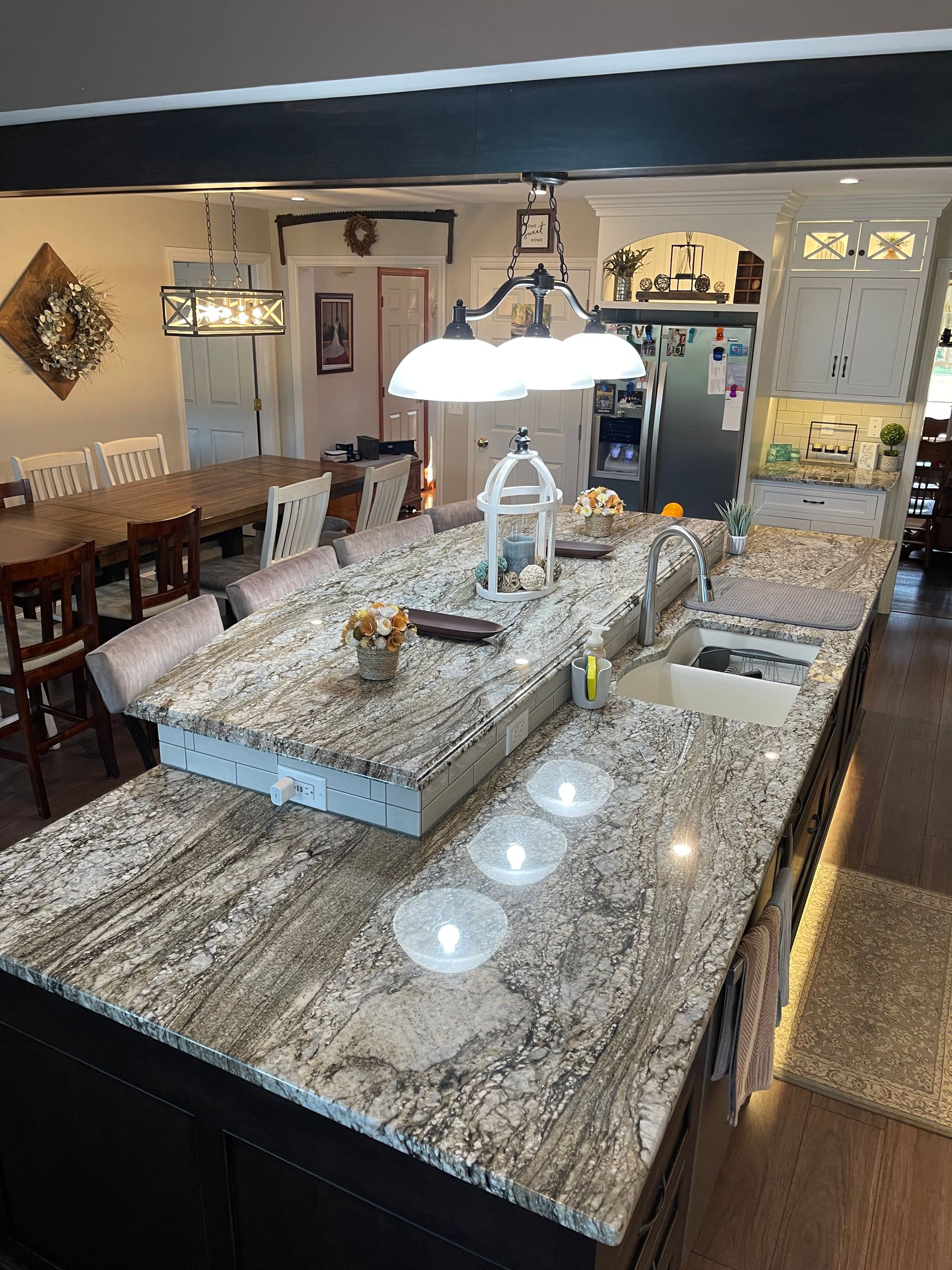 A kitchen with granite counter tops and a large island in the middle.