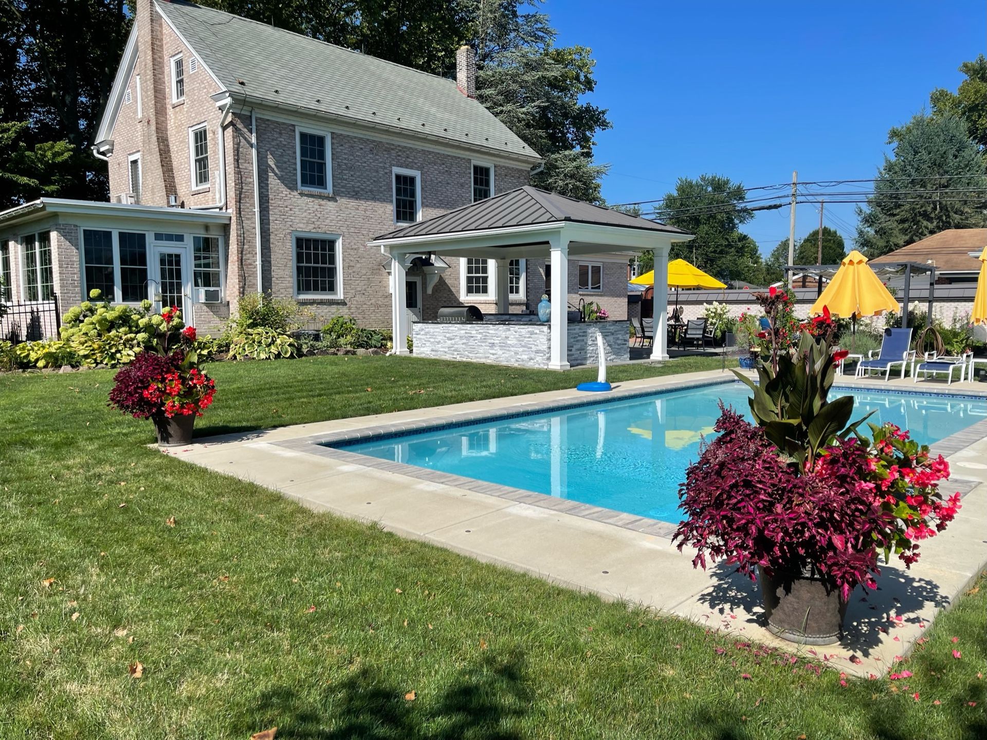 A large house with a swimming pool in front of it.
