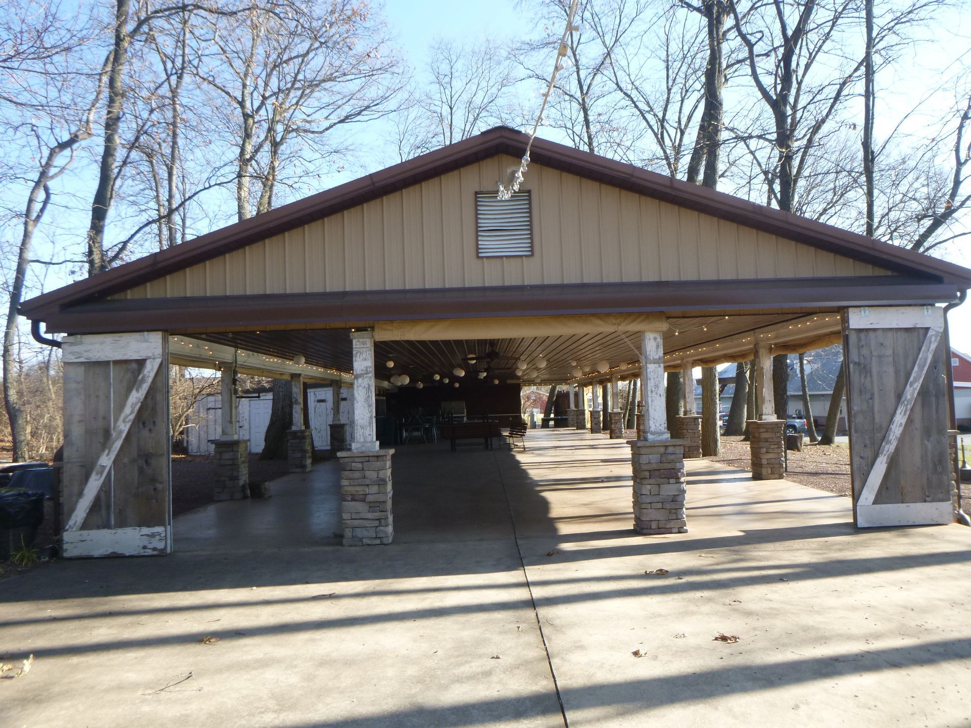A large building with a roof that is covered in trees.