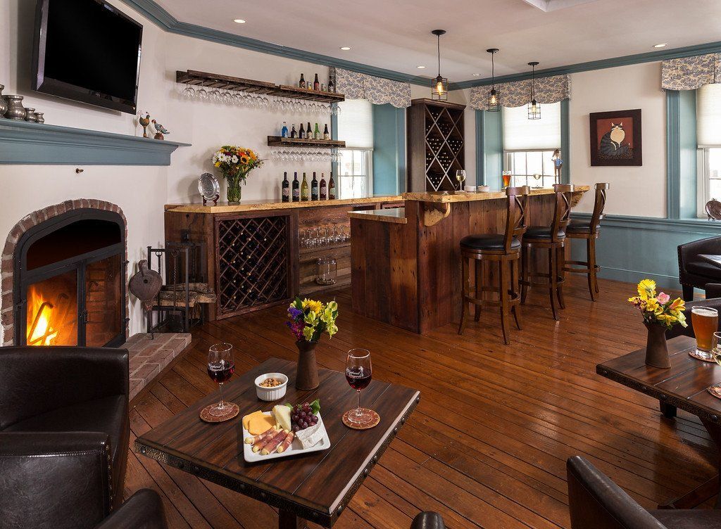 A living room with a fireplace and a bar