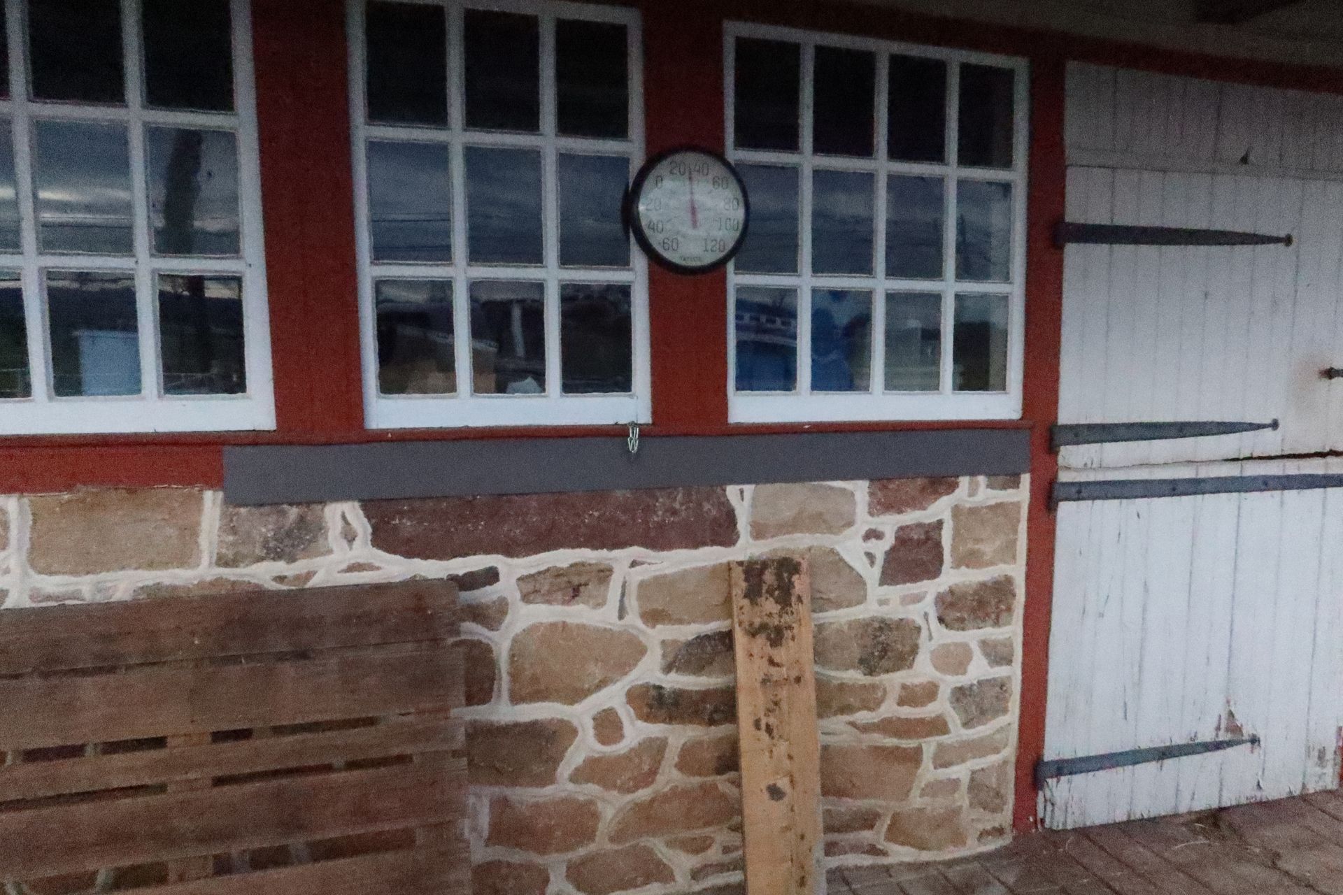 A clock is hanging on the wall of a building