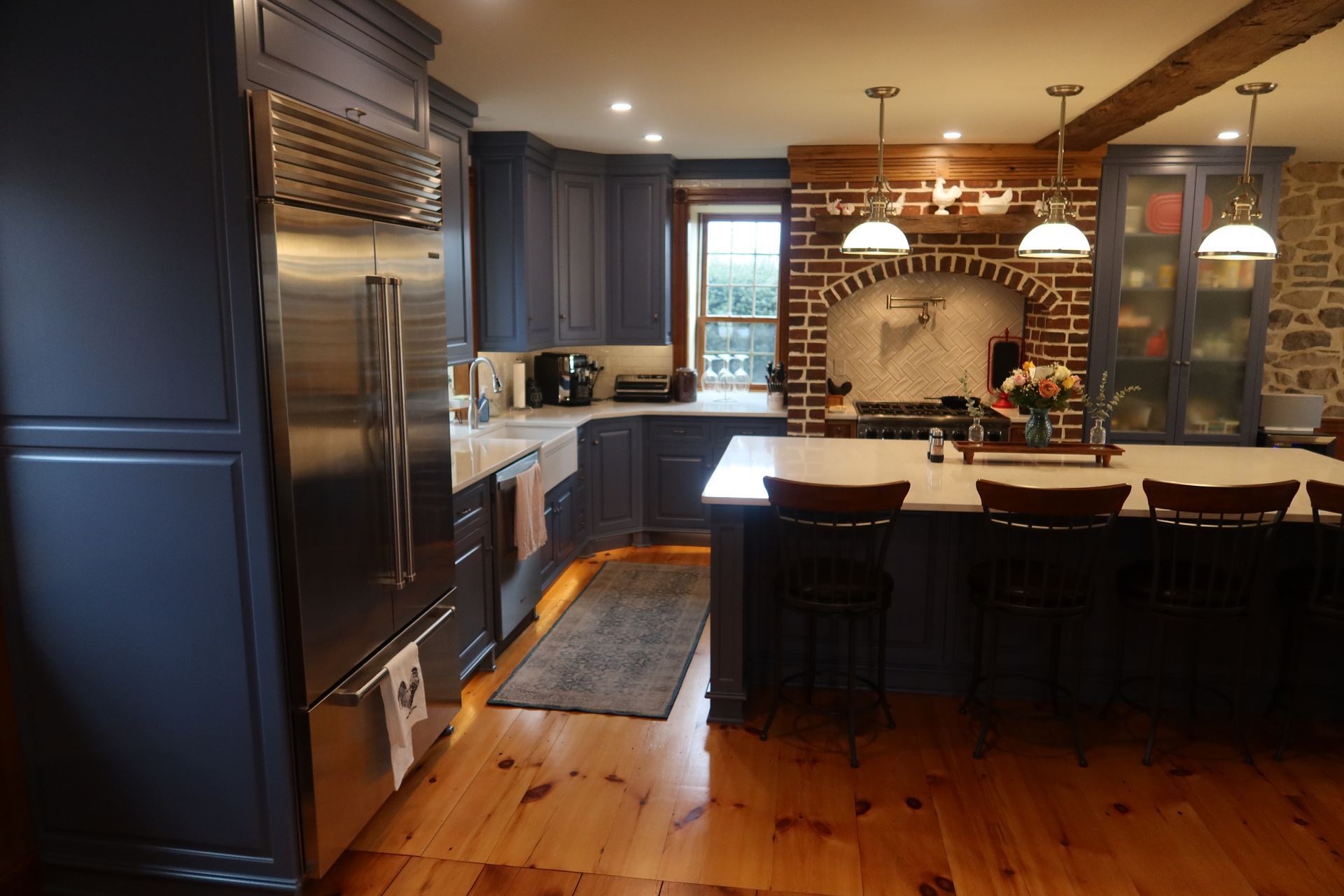 A kitchen with a large island and stainless steel appliances
