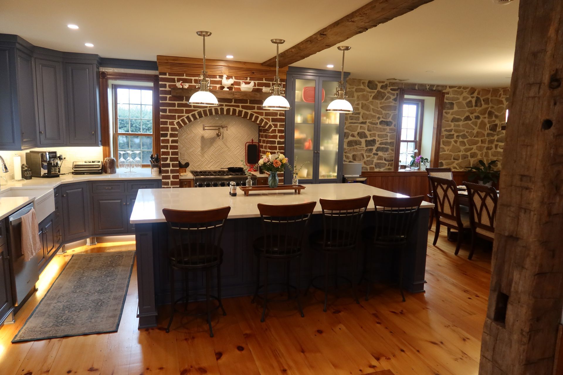 A kitchen with a large island and wooden floors