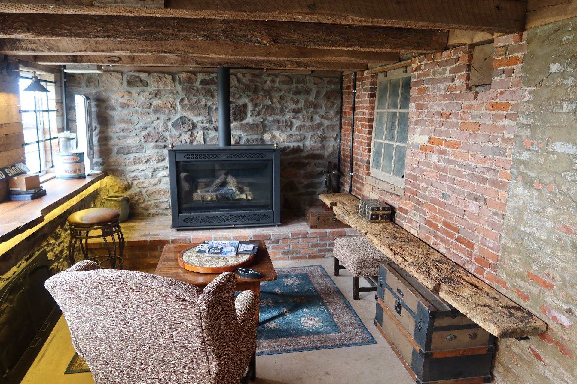 A living room with a fireplace and a brick wall