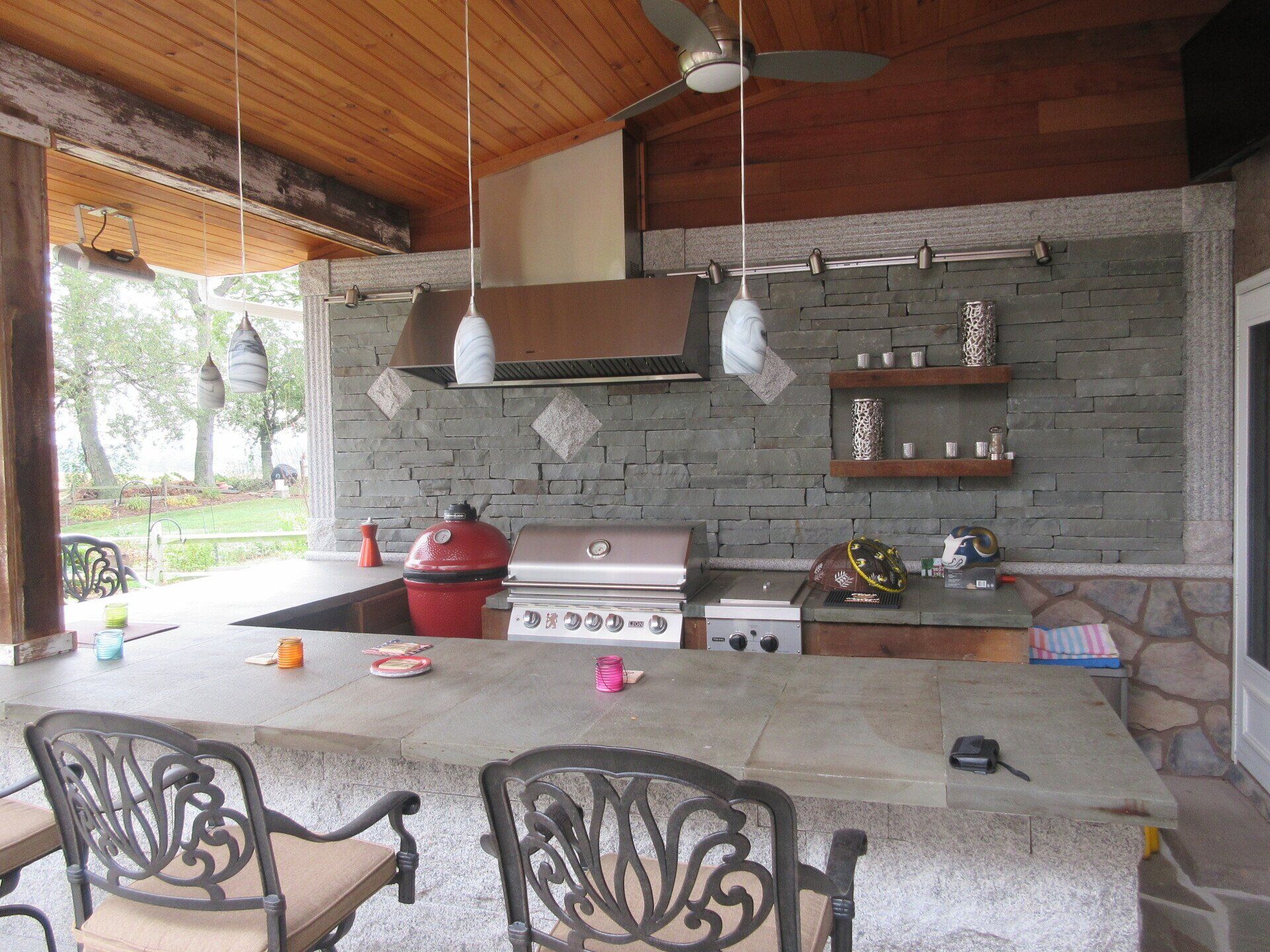 A kitchen with a stove and a ceiling fan