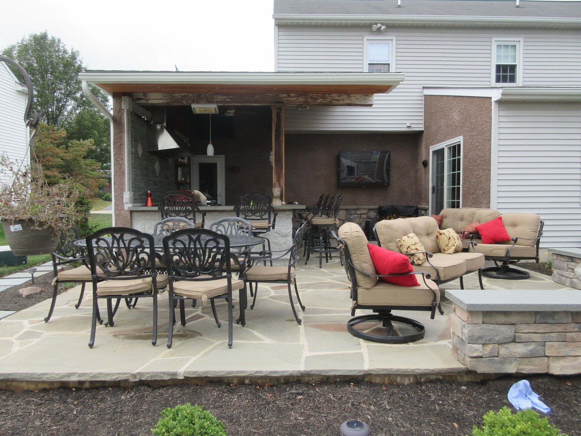 A patio with a table and chairs in front of a house.