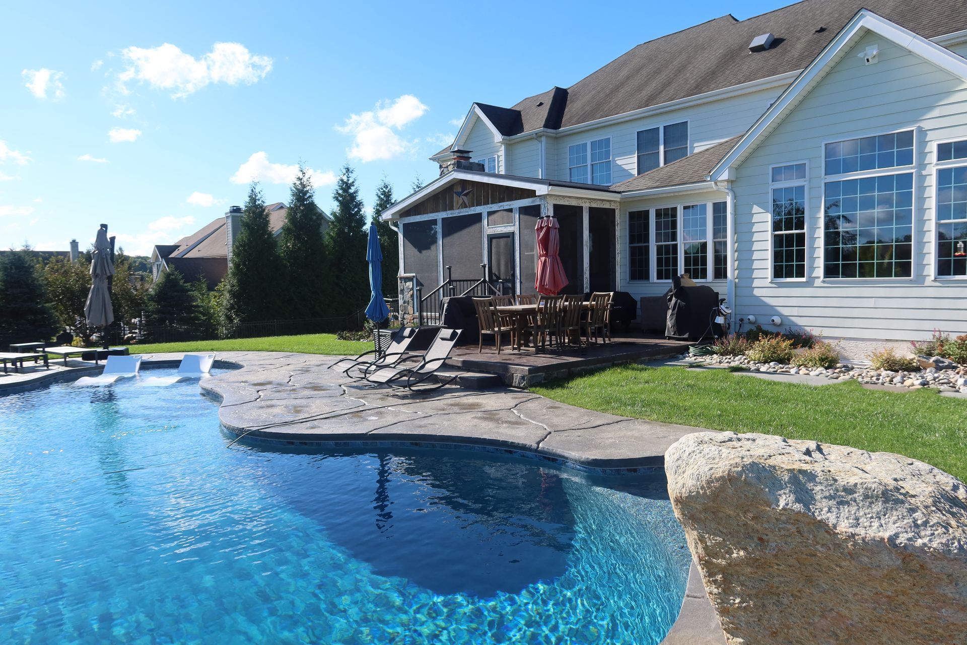 A large house with a large swimming pool in front of it