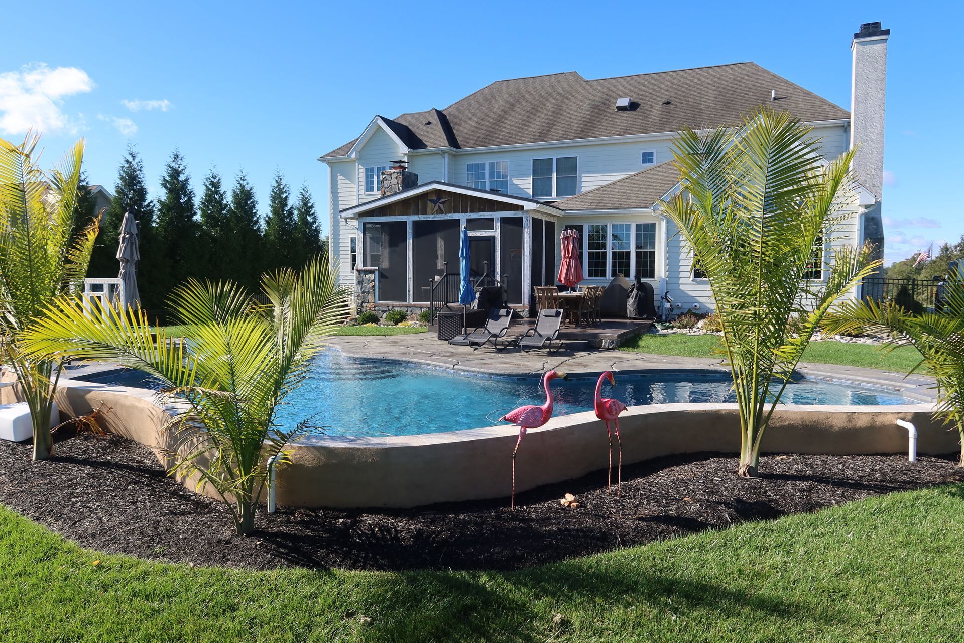 A large house with a swimming pool in front of it