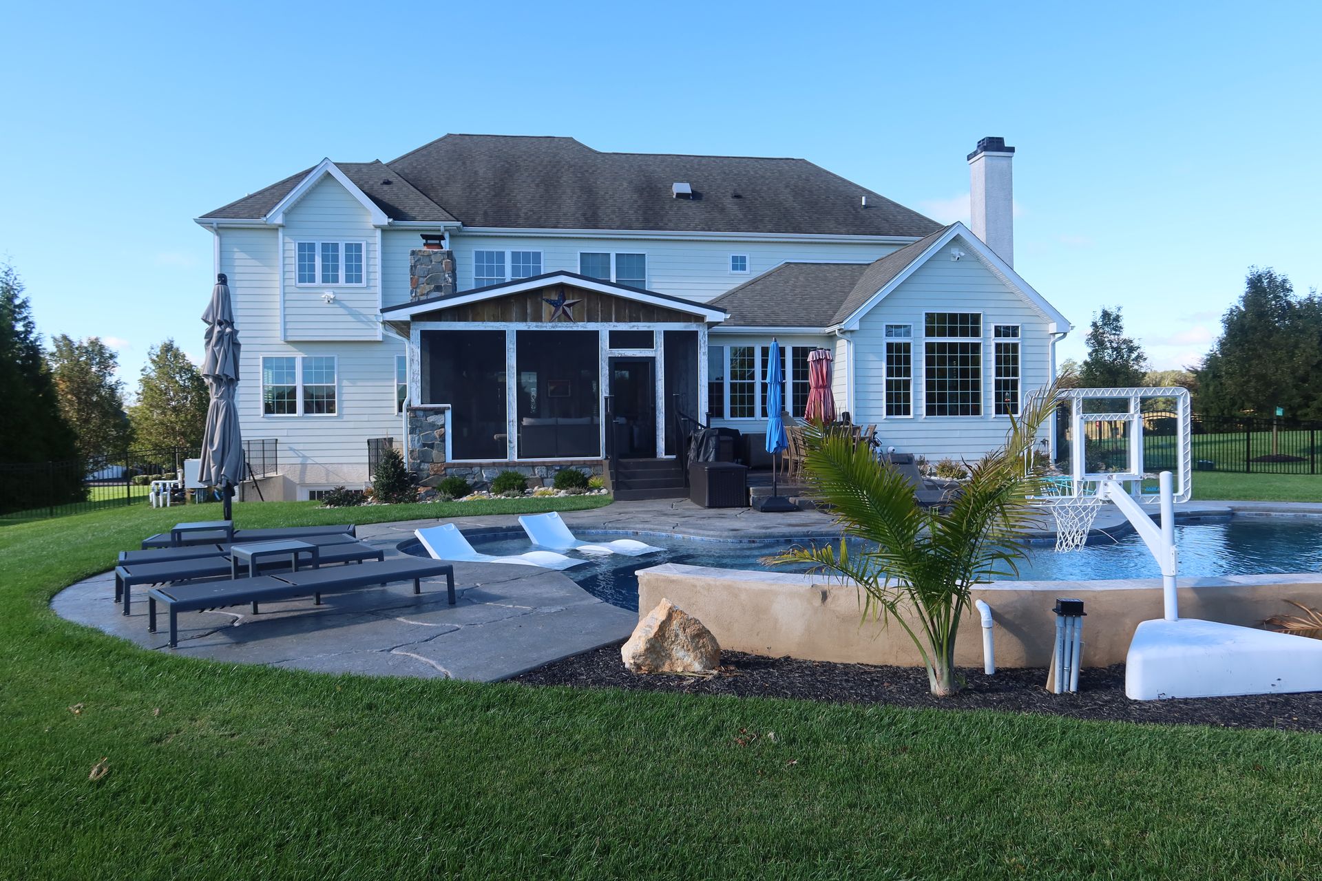 A large house with a swimming pool in front of it