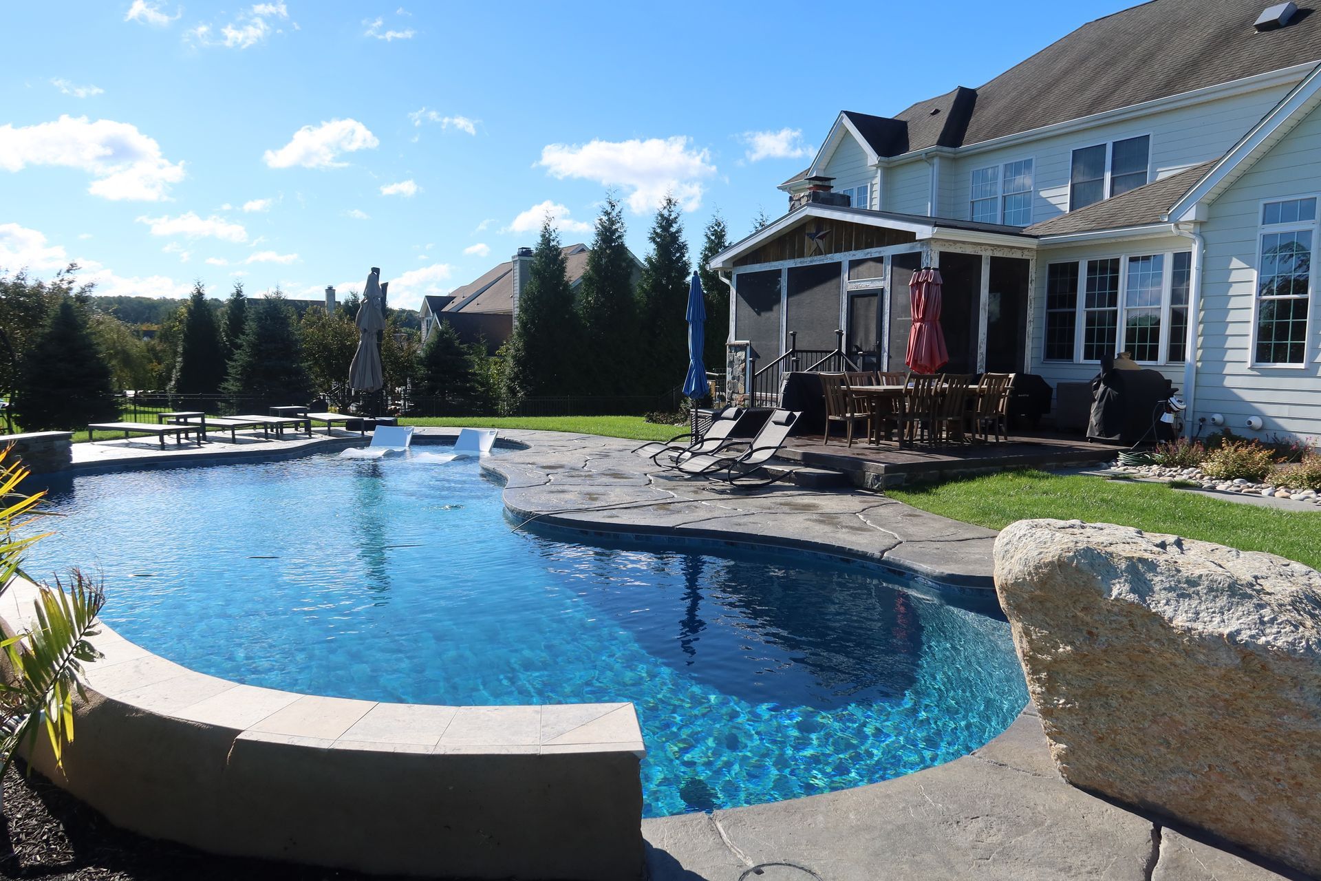A large swimming pool in the backyard of a house