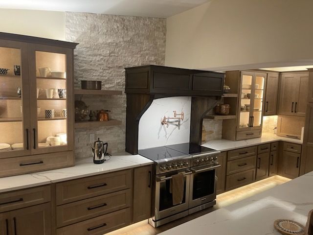 A kitchen with stainless steel appliances and wooden cabinets.