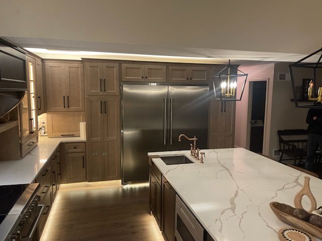 A kitchen with stainless steel appliances and wooden cabinets