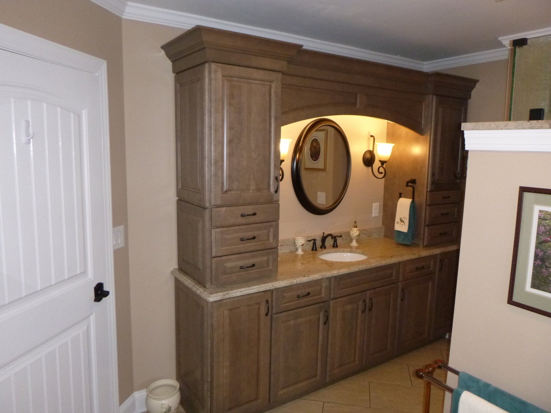 A bathroom with lots of cabinets and a sink
