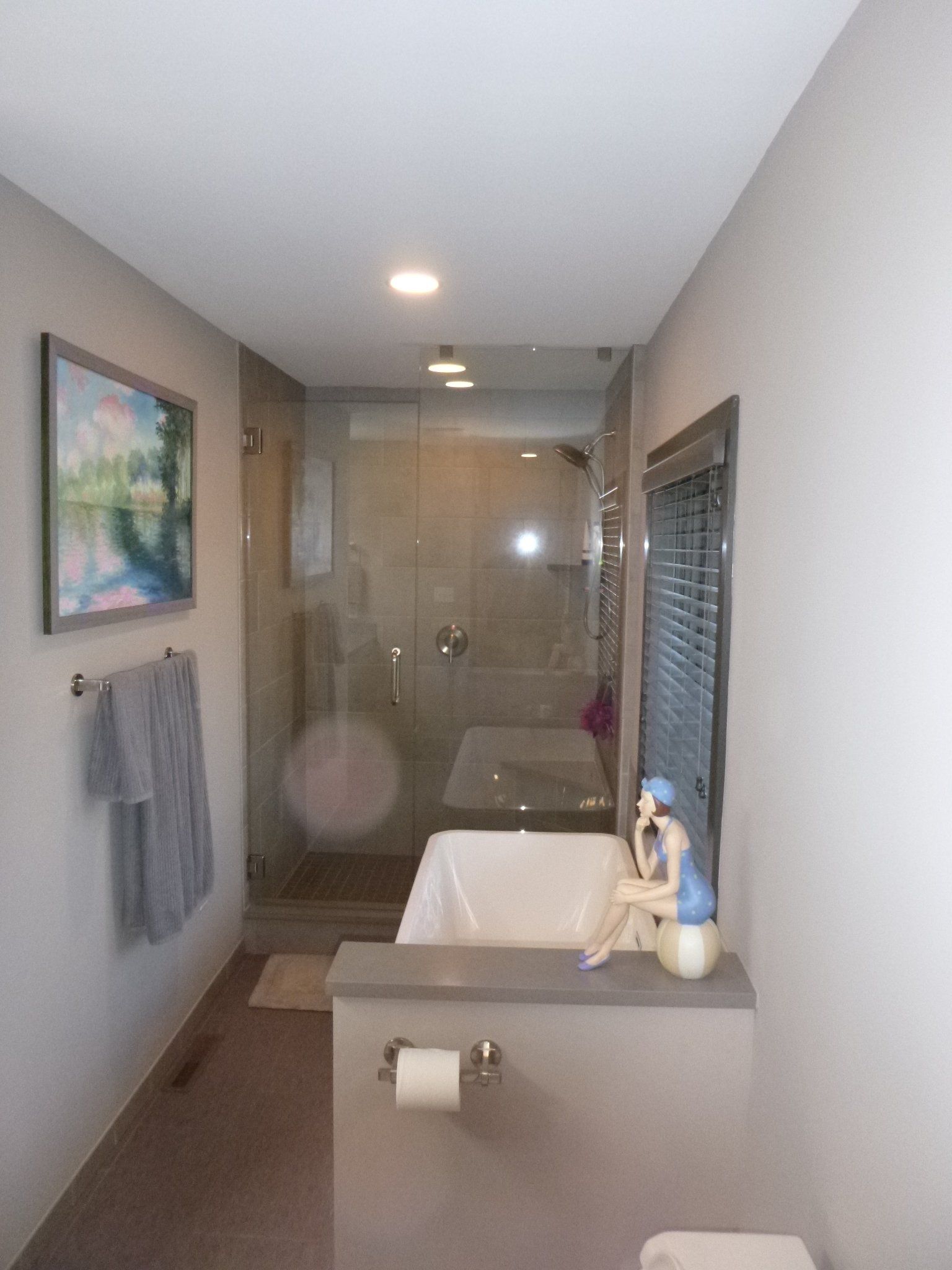 A bathroom with a tub and a picture on the wall