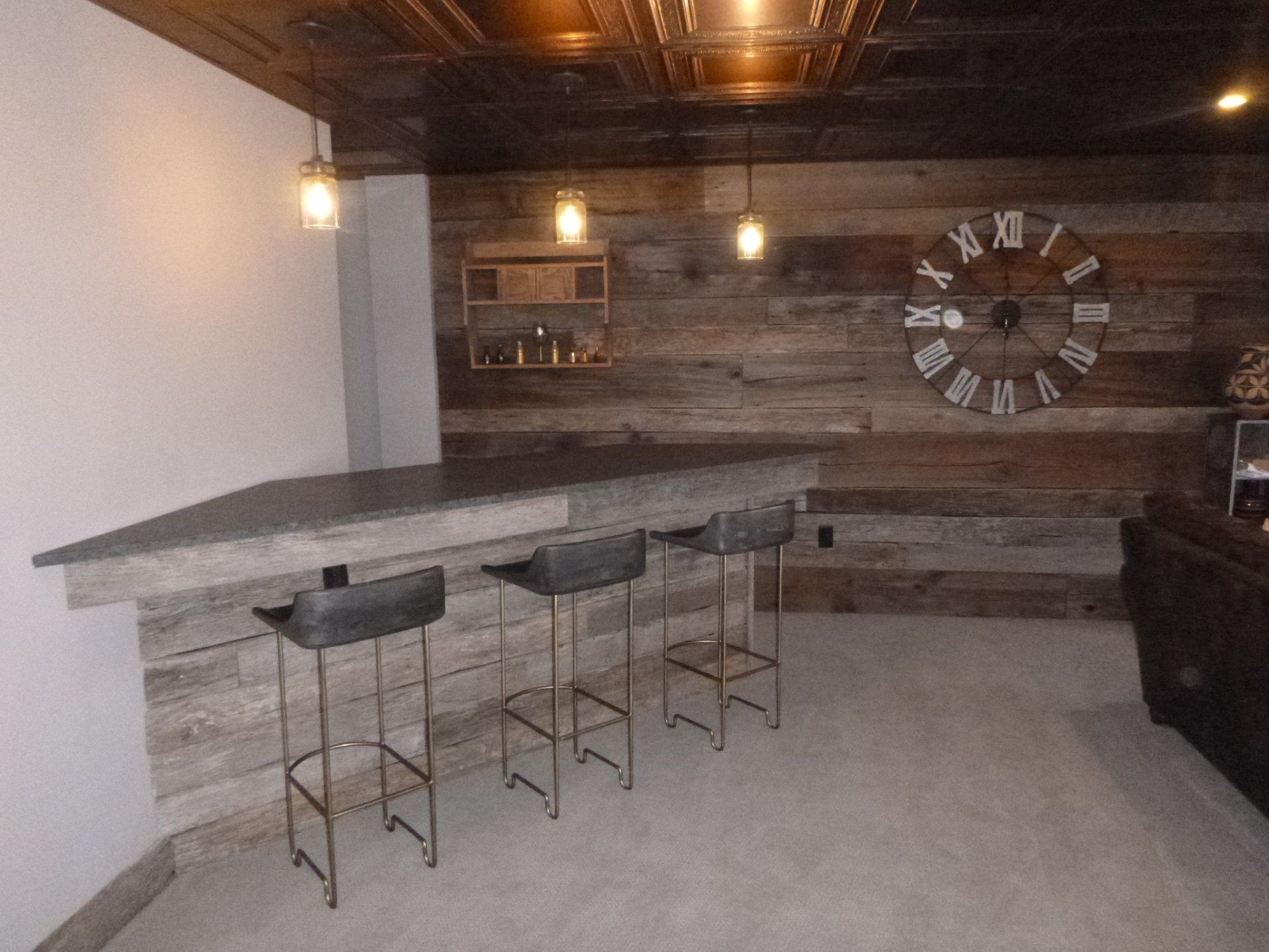 A bar with stools and a clock on the wall