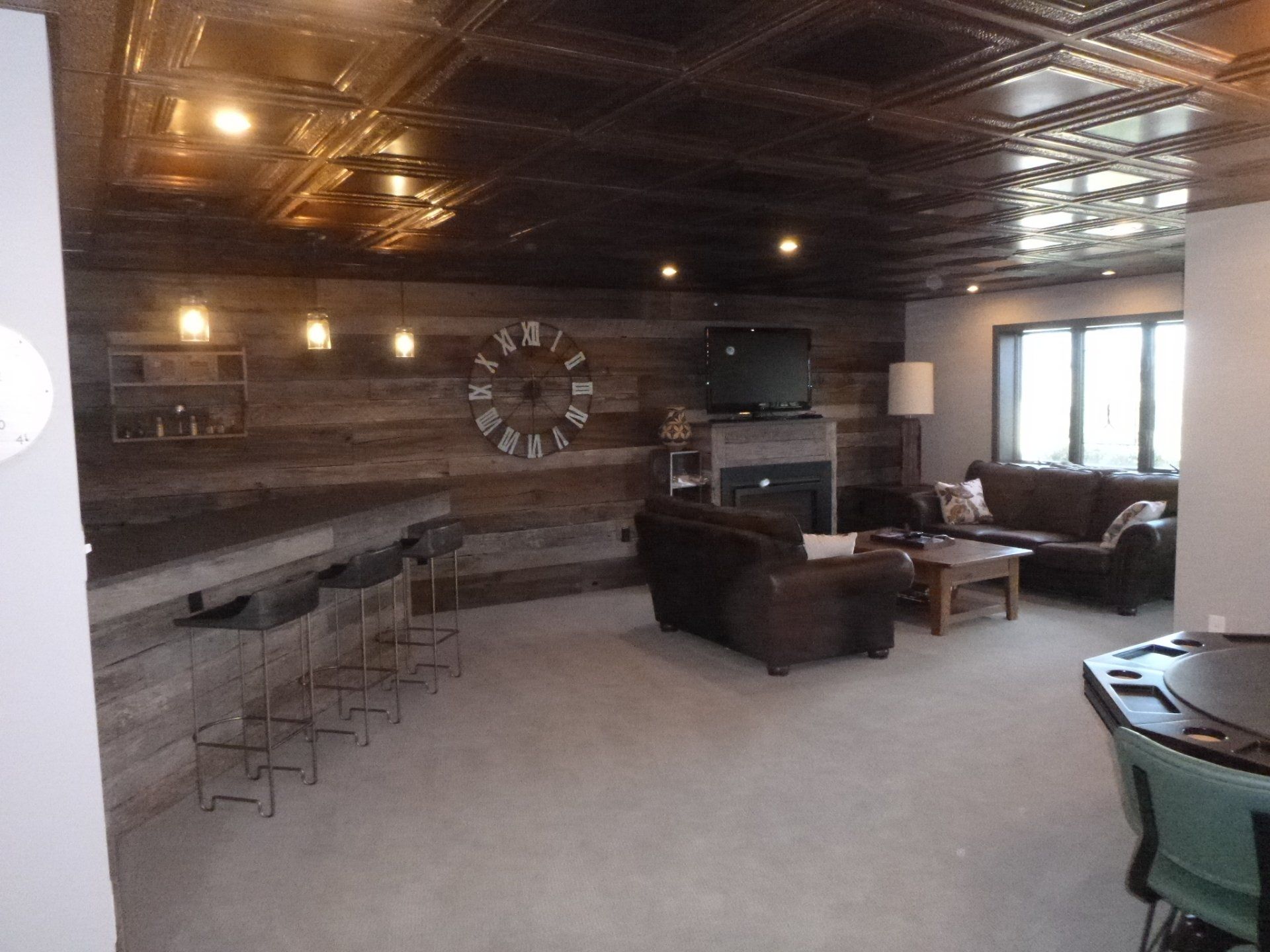 A living room with a fireplace and a clock on the wall